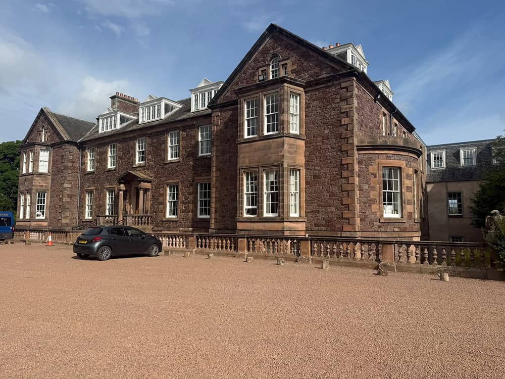 Renovated historic building with brick facade and large windows in the UK.